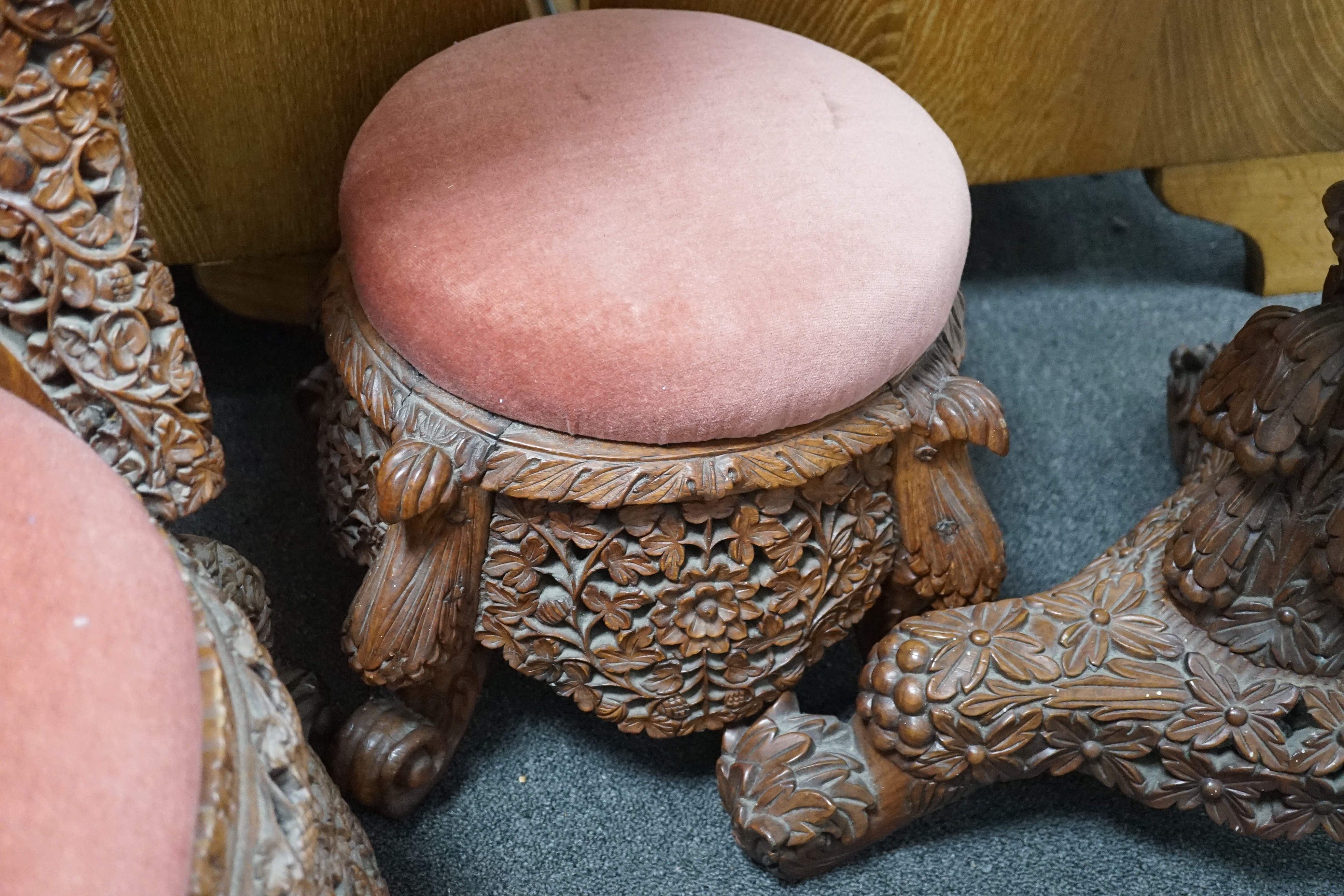 A Burmese carved hardwood circular occasional or centre table, diameter 57cm height 74cm, together with a similar side chair and foot stool